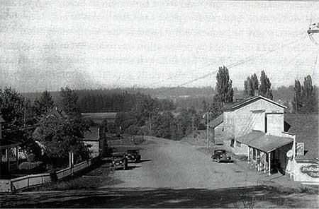 1938 photo looking north up Butte Street past the Butteville Store and Odd Fellows Hall. Note that the road down to the landing has become overgrown from disuse {Photo from Willamette Landings by Howard M. Corning]